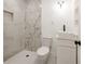 A bathroom featuring white marble, modern fixtures, hexagon floor tile and a built-in shower niche at 1032 26Th S Ave, St Petersburg, FL 33705