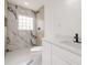 Modern bathroom featuring glass block window, shower, and white vanity at 1032 26Th S Ave, St Petersburg, FL 33705