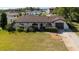 View of home's front exterior with manicured lawn, mature landscaping, and an attached two-car garage at 1032 26Th S Ave, St Petersburg, FL 33705