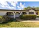 Front exterior of a charming home showcasing a welcoming entrance with manicured greenery and attached garage at 1032 26Th S Ave, St Petersburg, FL 33705