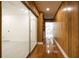 Bright hallway with built-in shelves, wood paneling and tile leading to rooms and closets at 1032 26Th S Ave, St Petersburg, FL 33705