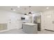 Well-lit kitchen with white cabinets, stainless steel appliances, center island with countertops, and pendant lighting at 1032 26Th S Ave, St Petersburg, FL 33705