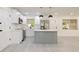 Bright kitchen boasts white cabinetry, stainless steel appliances, a center island, and stylish pendant lighting at 1032 26Th S Ave, St Petersburg, FL 33705