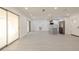 Bright open-concept living room with kitchen, white walls and light gray vinyl flooring at 1032 26Th S Ave, St Petersburg, FL 33705