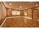 A cozy living room with wood-paneled walls, wood floors, recessed lighting, and a window at 1032 26Th S Ave, St Petersburg, FL 33705