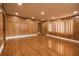 A cozy living room with wood-paneled walls, wood floors, and recessed lighting at 1032 26Th S Ave, St Petersburg, FL 33705