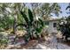 Inviting backyard area featuring lush greenery and a glimpse of the home at 10514 52Nd N Ave, St Petersburg, FL 33708