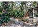 Lush backyard featuring a charming screened porch and beautiful landscaping at 10514 52Nd N Ave, St Petersburg, FL 33708