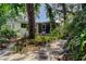 Serene backyard scene showcasing the screened porch and verdant surroundings at 10514 52Nd N Ave, St Petersburg, FL 33708