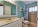 Bright bathroom featuring a white vanity and a walk-in shower with blue accents at 10514 52Nd N Ave, St Petersburg, FL 33708