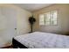 Cozy bedroom features a tree-framed window, a leafy plant and tiled floors at 10514 52Nd N Ave, St Petersburg, FL 33708