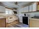 Classic kitchen featuring white cabinets, modern appliances, stylish flooring, and a window for natural light at 10514 52Nd N Ave, St Petersburg, FL 33708