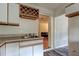 Kitchen area featuring functional sink and cabinets, perfect for culinary activities and storage at 10514 52Nd N Ave, St Petersburg, FL 33708