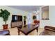 Comfortable living room with a sleek TV and modern media center, open to the dining area at 10514 52Nd N Ave, St Petersburg, FL 33708