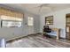 Bright living room with a ceiling fan and a window, complete with desk and a door leading to the exterior at 10514 52Nd N Ave, St Petersburg, FL 33708