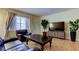Cozy living room featuring a large window, stylish seating, and a modern entertainment unit at 10514 52Nd N Ave, St Petersburg, FL 33708