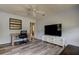 Well-lit living room featuring modern flooring, a ceiling fan, and plenty of space for relaxation and entertainment at 10514 52Nd N Ave, St Petersburg, FL 33708