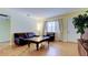 Inviting living room with hardwood floors, comfortable seating, and a large window for natural light at 10514 52Nd N Ave, St Petersburg, FL 33708