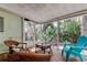 Inviting screened porch featuring wicker furniture and a relaxing outdoor space at 10514 52Nd N Ave, St Petersburg, FL 33708