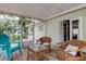 Charming screened porch with comfortable seating and peaceful outdoor views at 10514 52Nd N Ave, St Petersburg, FL 33708