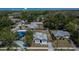 Aerial shot of a neighborhood featuring houses with tree coverage and a water tower in the background at 1138 Howard St, Clearwater, FL 33756