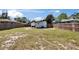 Large backyard with fenced yard and white rock patio sitting area at 1138 Howard St, Clearwater, FL 33756