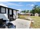 Backyard with white rock patio, fenced yard, shed, seating, and lush lawn at 1138 Howard St, Clearwater, FL 33756