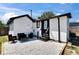 View of the backyard with white rock patio, cozy seating, and fenced yard at 1138 Howard St, Clearwater, FL 33756