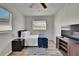 Cozy bedroom features natural light, ceiling fan, and hardwood flooring at 1138 Howard St, Clearwater, FL 33756