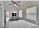 Bright bedroom with black metal bedframe, ceiling fan, and natural light from dual windows at 1138 Howard St, Clearwater, FL 33756
