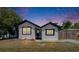 Charming single-story home featuring a freshly painted white exterior, black trim, and a well-maintained front yard at 1138 Howard St, Clearwater, FL 33756