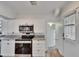 Updated kitchen features stainless appliances, granite counters, and white cabinetry at 1138 Howard St, Clearwater, FL 33756