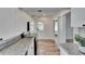 Bright kitchen features stainless appliances, granite counters, and wood floors at 1138 Howard St, Clearwater, FL 33756