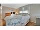 Comfortable bedroom with floral bedding and ample storage featuring natural light and modern accents at 128 E Saint Johns Way, Apollo Beach, FL 33572