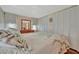 Well-lit bedroom offers ample storage space with sliding closet doors and a dresser with mirror at 128 E Saint Johns Way, Apollo Beach, FL 33572