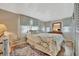 Comfortable bedroom with a queen-sized bed, dresser, and soft natural lighting at 128 E Saint Johns Way, Apollo Beach, FL 33572