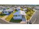 Charming blue single-story home with covered parking and well-maintained landscaping in a quiet community at 128 E Saint Johns Way, Apollo Beach, FL 33572