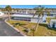 Inviting single-story home with covered parking, surrounded by lush greenery and a clear blue sky at 128 E Saint Johns Way, Apollo Beach, FL 33572