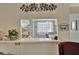 Charming kitchen view with pass-through window, white cabinets, and decorative wall art at 128 E Saint Johns Way, Apollo Beach, FL 33572