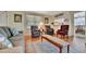Inviting living room with a view to the kitchen area, complete with comfortable seating and laminate flooring at 128 E Saint Johns Way, Apollo Beach, FL 33572