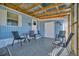 Relaxing covered patio space with a table and chairs, perfect for enjoying the outdoors at 128 E Saint Johns Way, Apollo Beach, FL 33572