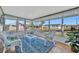 Cozy sunroom with wicker furniture, bright windows, and an inviting blue rug at 128 E Saint Johns Way, Apollo Beach, FL 33572