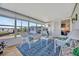 Bright sunroom with large windows, wood floors, and comfortable seating arrangement with view of exterior at 128 E Saint Johns Way, Apollo Beach, FL 33572