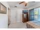 This bedroom has neutral carpet and paint, a ceiling fan, and a large window at 1313 E Cayuga St, Tampa, FL 33603