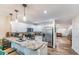Modern kitchen with stainless steel appliances, white cabinetry, granite countertops, and a breakfast bar at 1313 E Cayuga St, Tampa, FL 33603