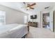 Spacious main bedroom with ceiling fan, natural light, and doorway to ensuite bathroom at 1313 E Cayuga St, Tampa, FL 33603