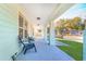 Inviting front porch with ample seating area, perfect for relaxing and enjoying the neighborhood views at 1313 E Cayuga St, Tampa, FL 33603