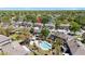Aerial view of the community featuring a pool, mature trees, and well-maintained townhomes at 14019 Notreville Way, Tampa, FL 33624