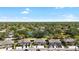 Aerial view of a well-maintained community with lush landscaping and a tranquil pond at 14019 Notreville Way, Tampa, FL 33624