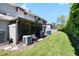 A cozy back patio with screened in porch and grassy yard provide a relaxing outdoor space at 14019 Notreville Way, Tampa, FL 33624